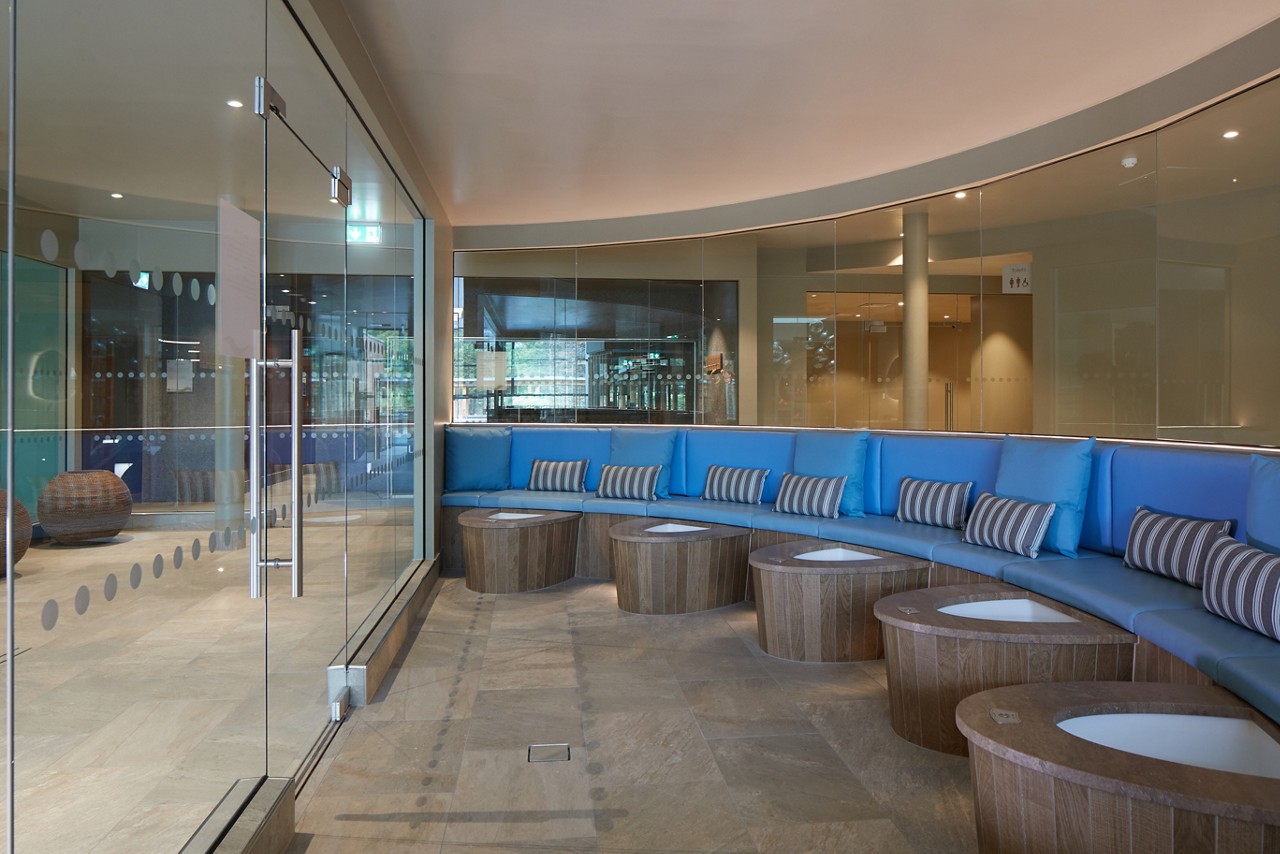 Curved seating alongside bubbling Sole Therapy footbaths.